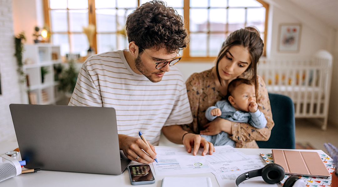 Photo of a young family working on financial planning at a laptop